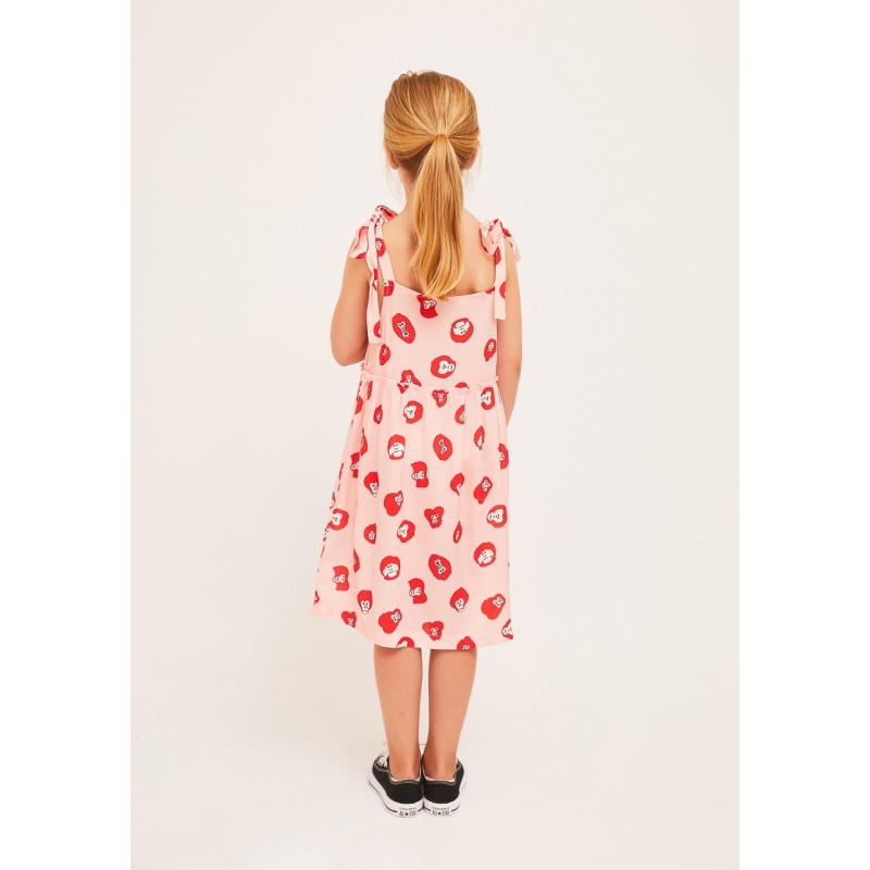 Vestido de niña estampado en color rosa con ilustración de monitos en rojo y blanco